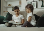 Kids Reading a Book on the Couch
